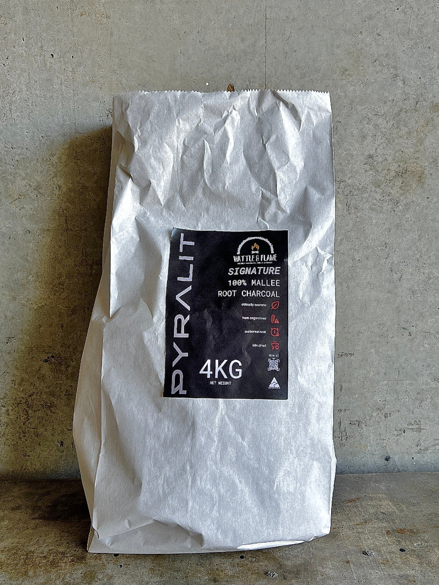 White bag of Pyralit charcoal with a black label on a concrete floor.