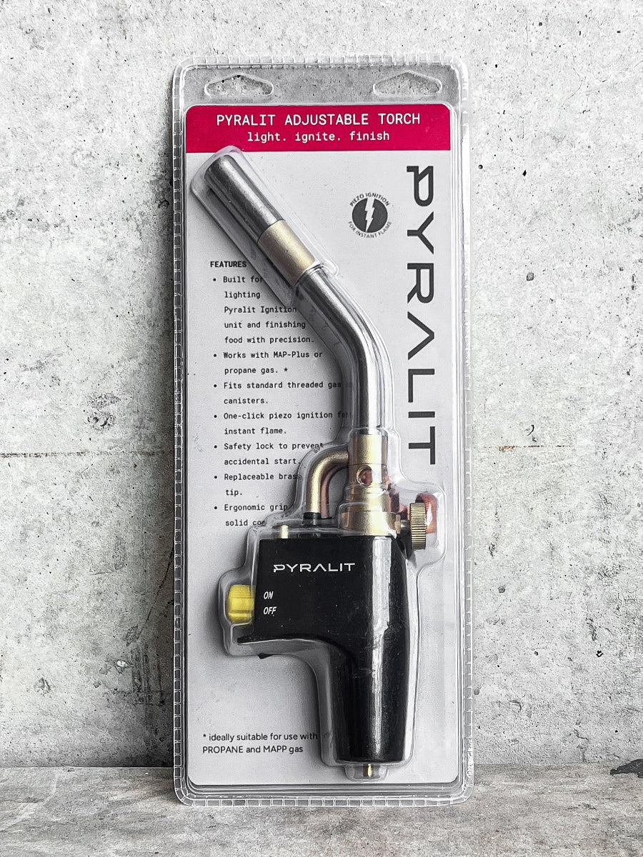 Pyralit adjustable torch in packaging on a textured gray background