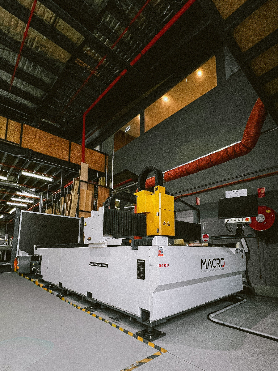 Large industrial machine with 'MACRO' branding in a warehouse setting
